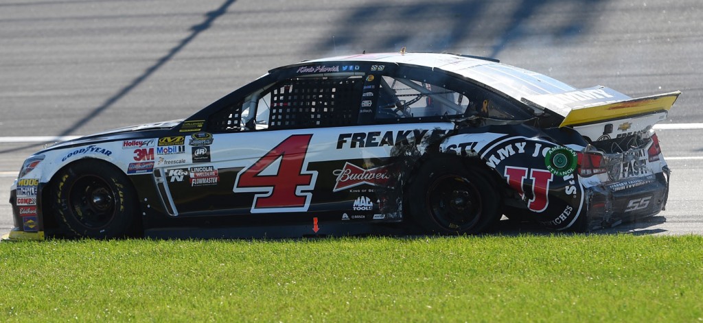 Kevin Harvick sits in teh grass after an incident that damaged his race car (photo - NASCAR via Getty Images)